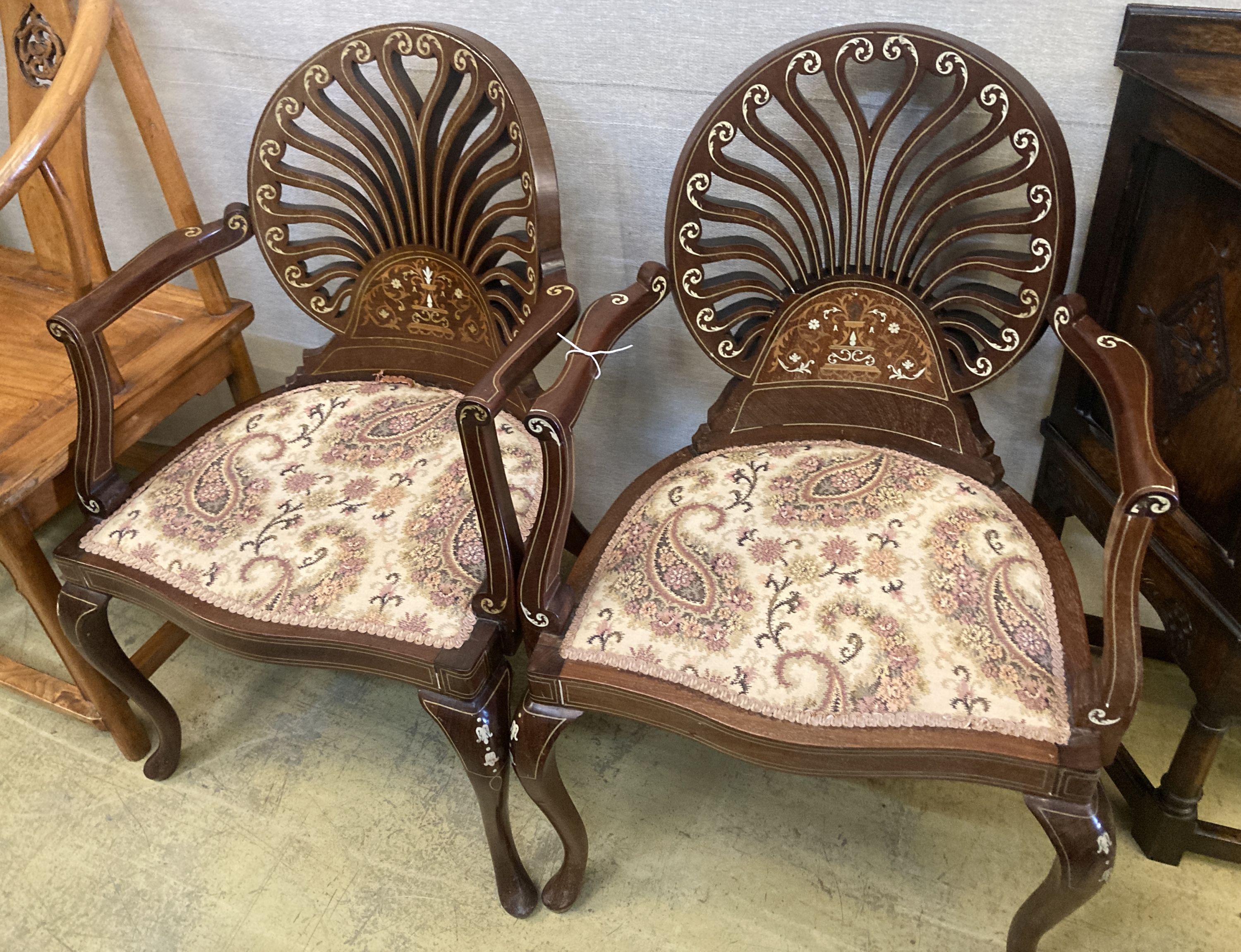 A pair of late Victorian inlaid mahogany elbow chairs, width 57cm, depth 46cm, height 87cm